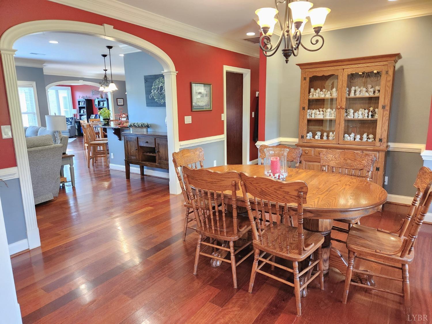 623 Two Bid Road Evington, VA 24550 - Photo 24 of 97 a dining room with wooden floor a chandelier a wooden table and chairs