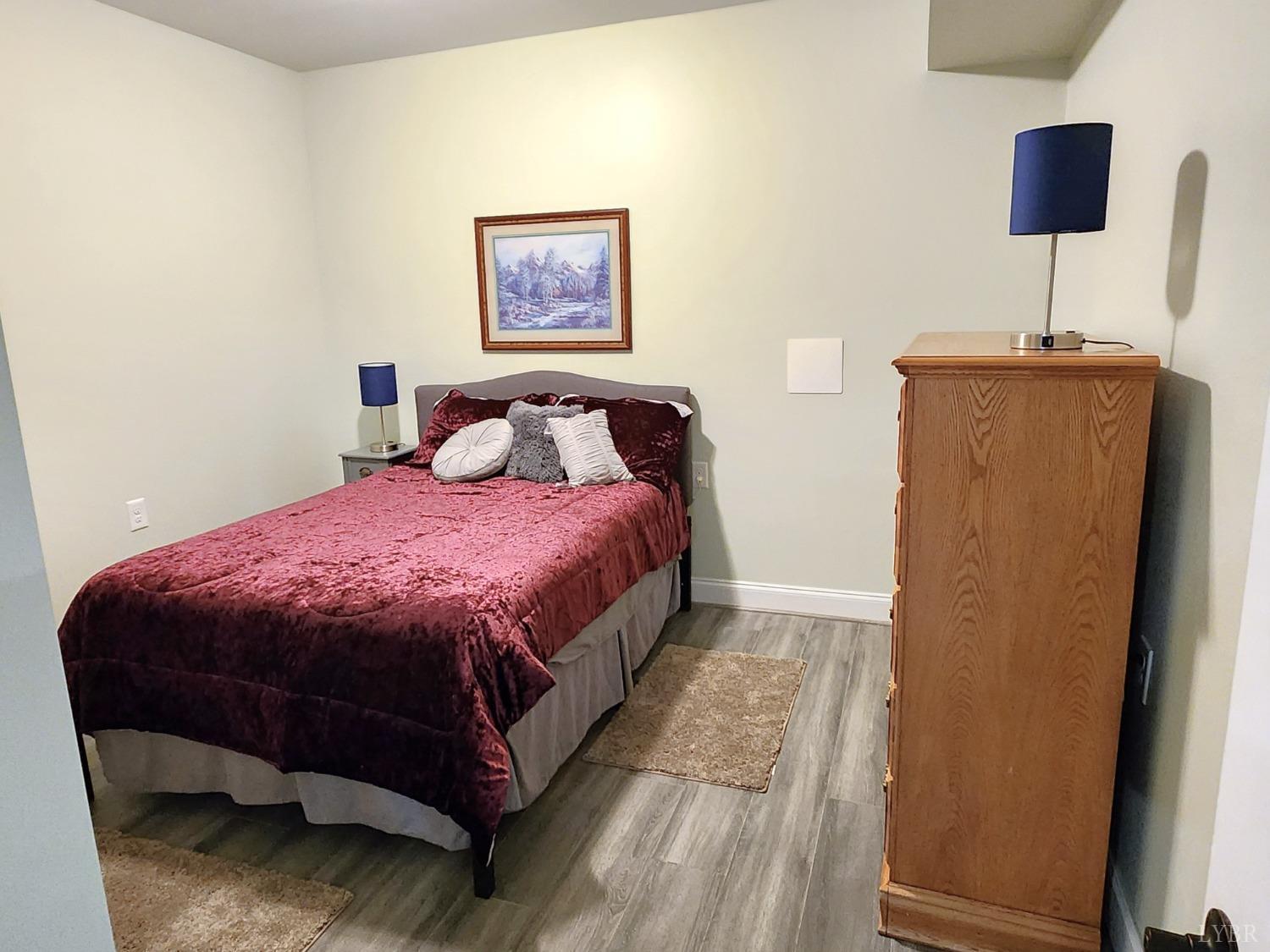 623 Two Bid Road Evington, VA 24550 - Photo 72 of 97 a spacious bedroom with a bed and a lamp on table