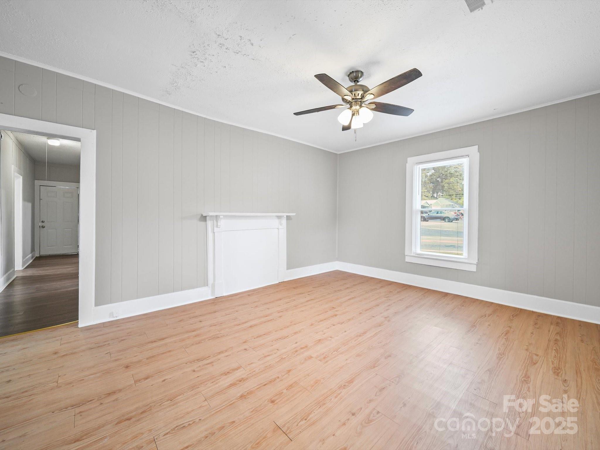 863 Old Charlotte Road Southwest Concord, NC 28027 - Photo 16 of 38 a view of an empty room with window and wooden floor