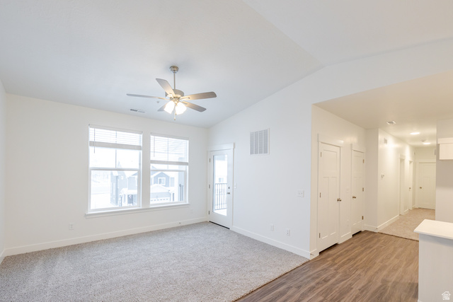 709 West 4500th South, Unit N301 Mapleton, UT 84664 - Photo 15 of 17 Unfurnished room featuring vaulted ceiling, light wood finished floors, ceiling fan, and light carpet