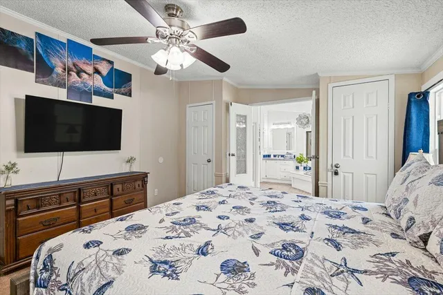 a bedroom with a large bed and a flat screen tv