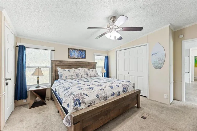 a bedroom with a bed and a lamp