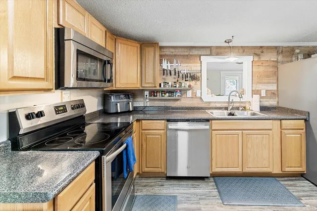 a kitchen with stainless steel appliances granite countertop a stove and white cabinets