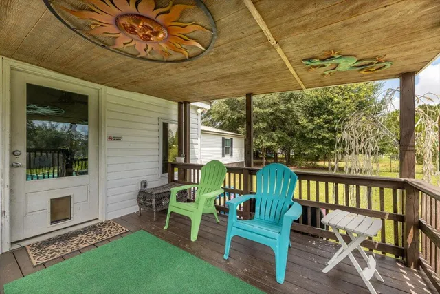 a view of a yard with swimming pool and sitting area