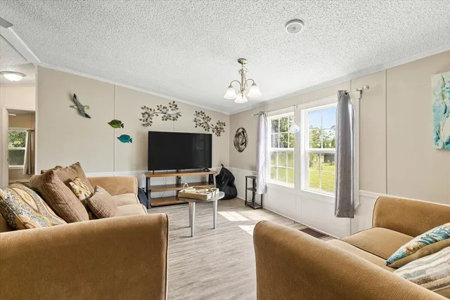 a spacious bedroom with a bed and a flat screen tv