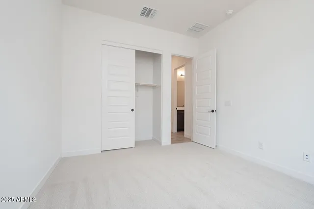 an empty room with closet area