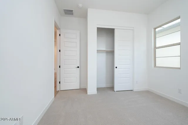 an empty room that has a grey walls