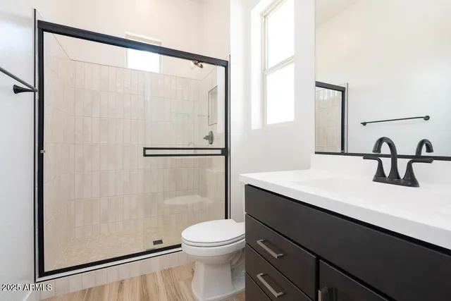 a bathroom with a sink a toilet and a mirror