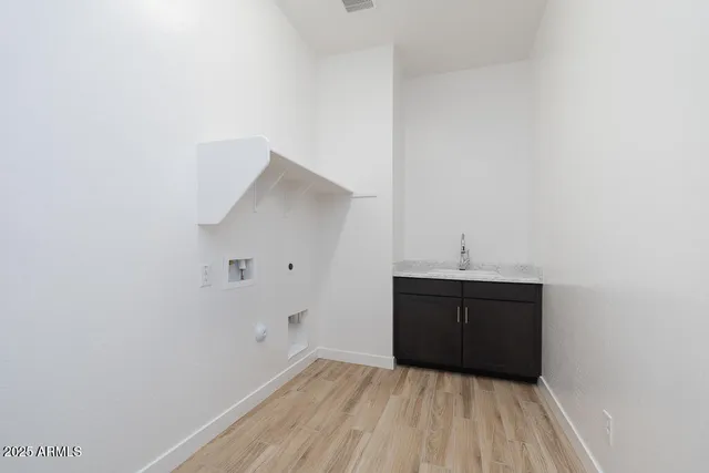a view of a room with wooden floor and cabinet