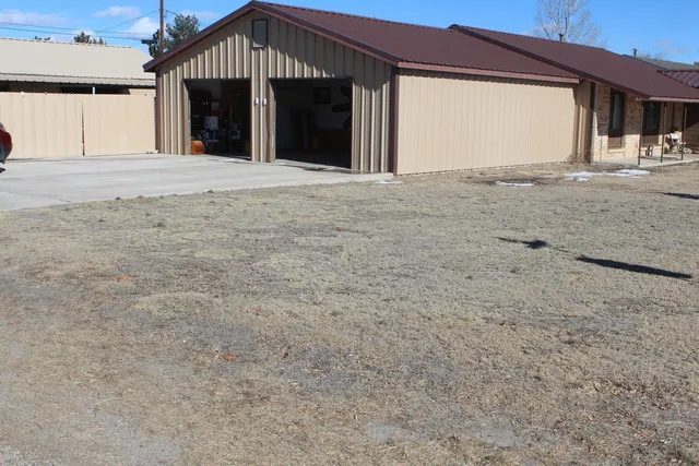 a front view of a house with a yard and a garage