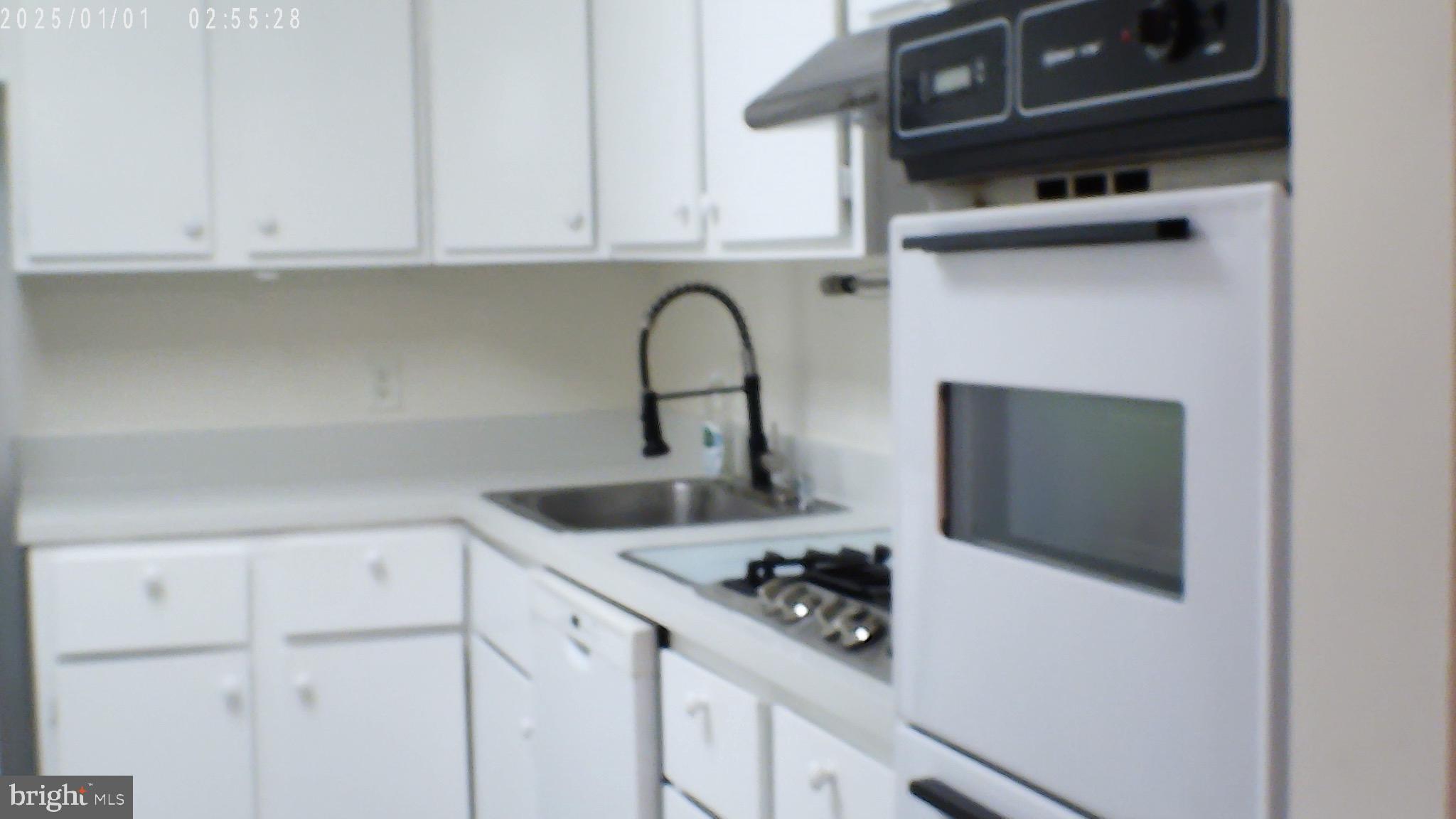 5101 River Road, Unit 1103 Bethesda, MD 20816 - Photo 15 of 22 a kitchen with a sink and cabinets