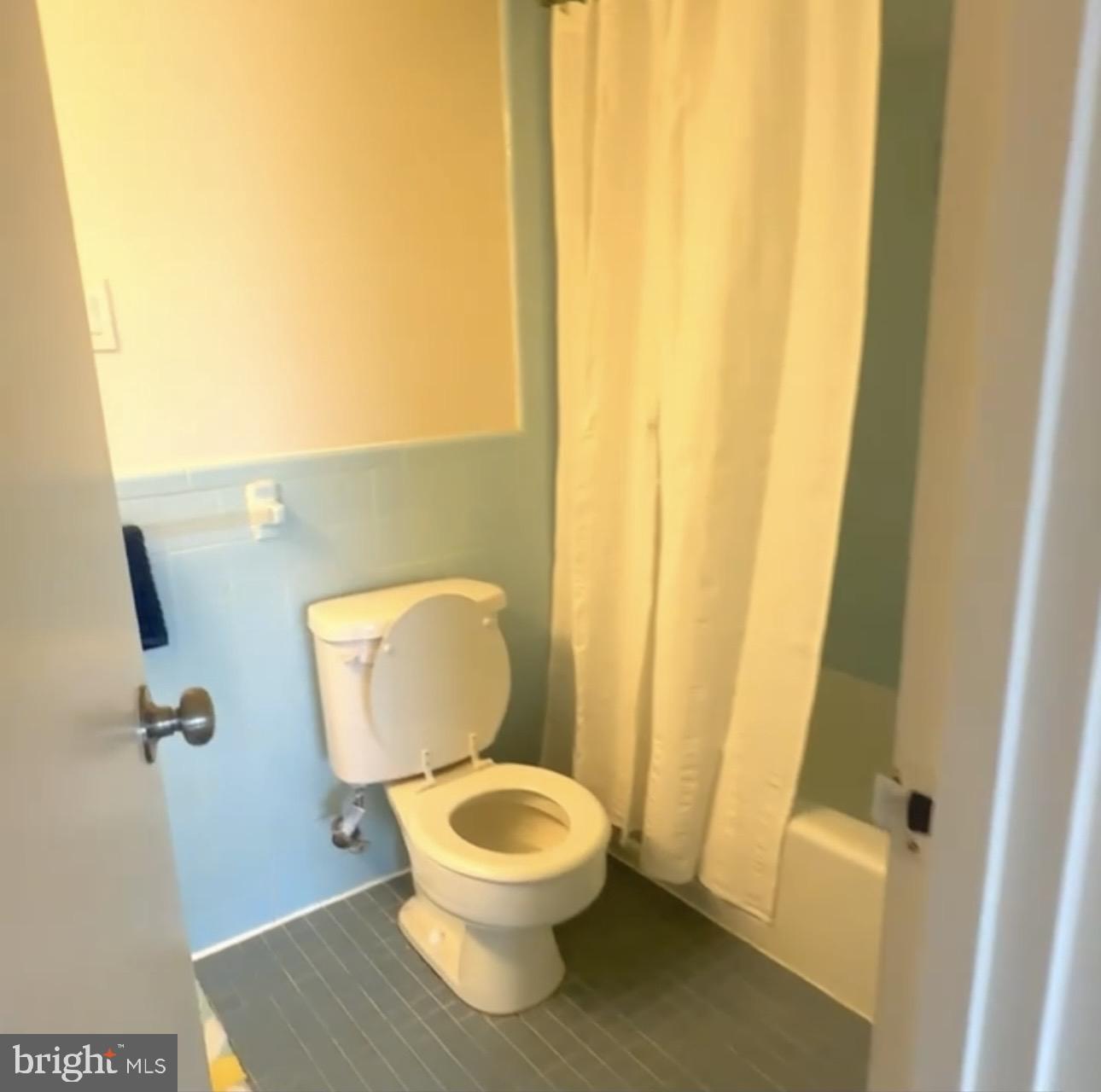 5101 River Road, Unit 1103 Bethesda, MD 20816 - Photo 17 of 22 a white toilet sitting next to a shower