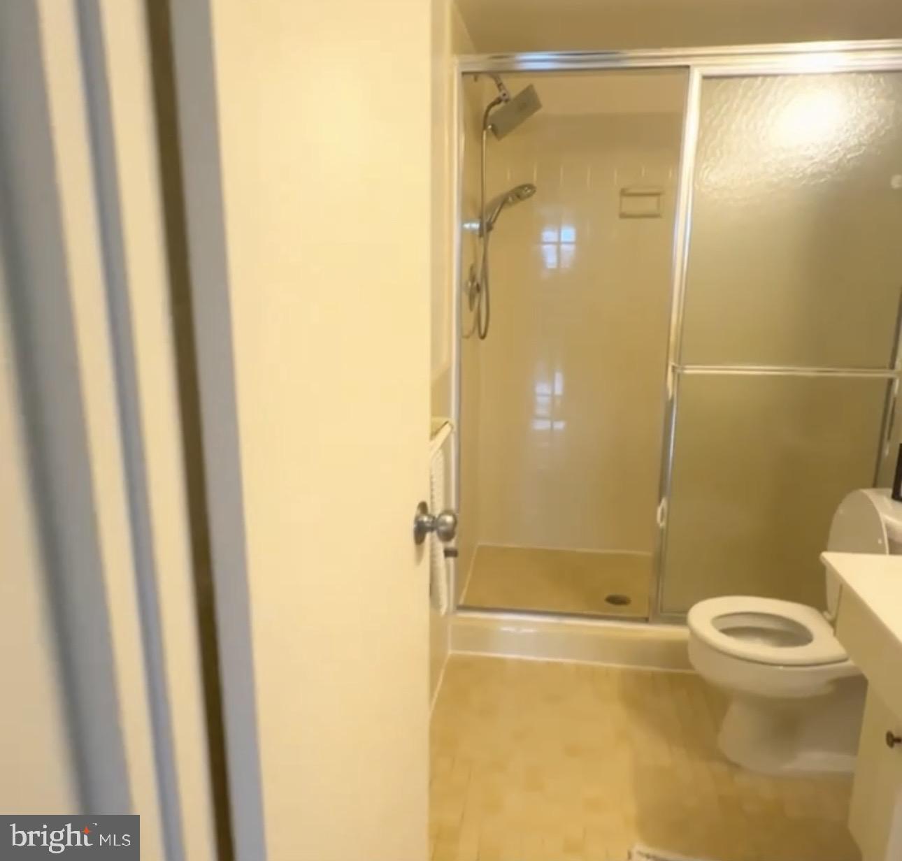 5101 River Road, Unit 1103 Bethesda, MD 20816 - Photo 18 of 22 a bathroom with a shower and a toilet