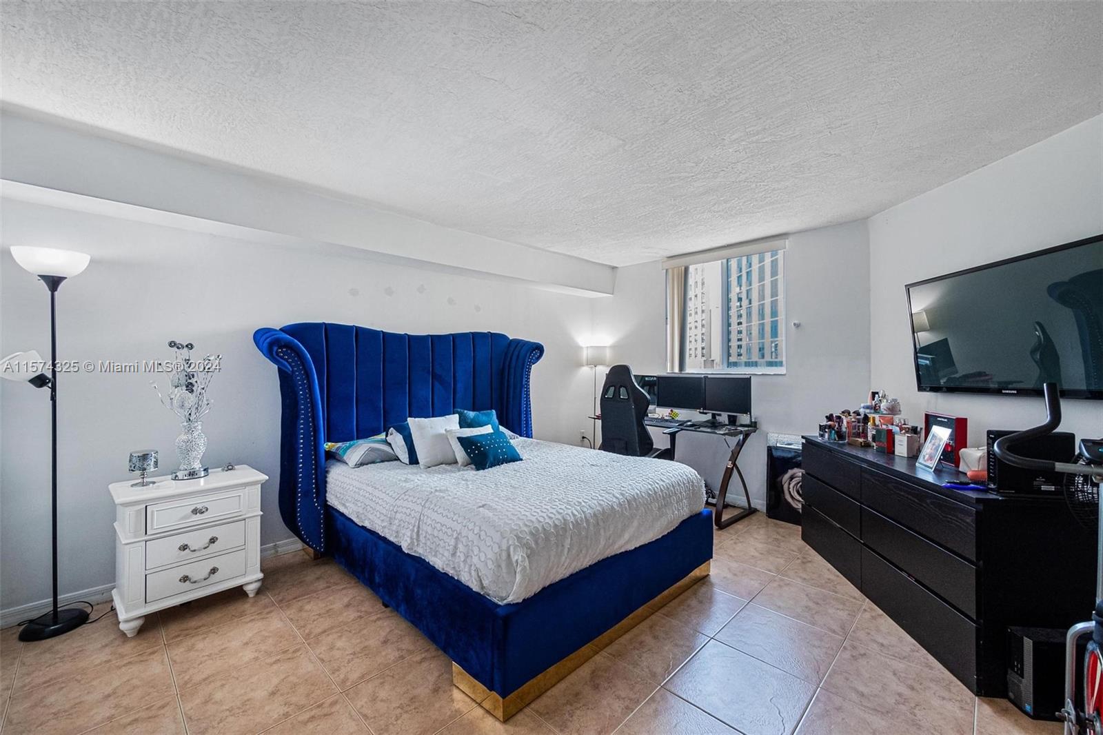 102 Southwest 6th Avenue, Unit 401 Miami, FL 33130 - Photo 15 of 27 a bedroom with a bed and a dresser in it