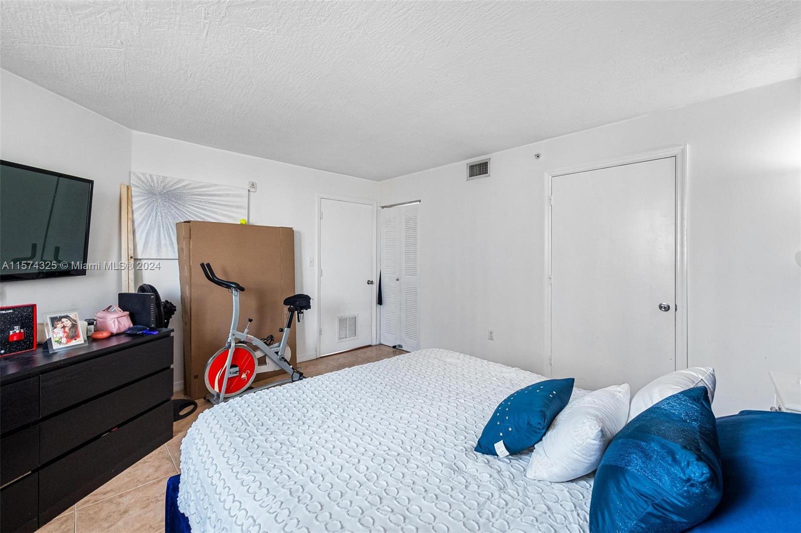 102 Southwest 6th Avenue, Unit 401 Miami, FL 33130 - Photo 16 of 27 a bedroom with a bed and a tv