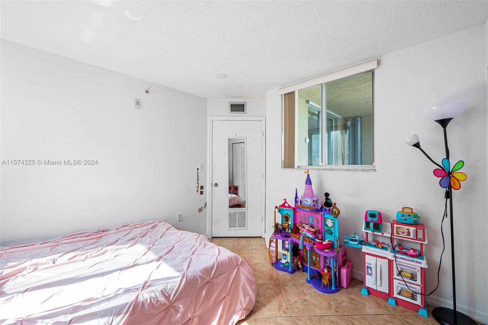 102 Southwest 6th Avenue, Unit 401 Miami, FL 33130 - Photo 21 of 27 a bedroom with bed and a closet