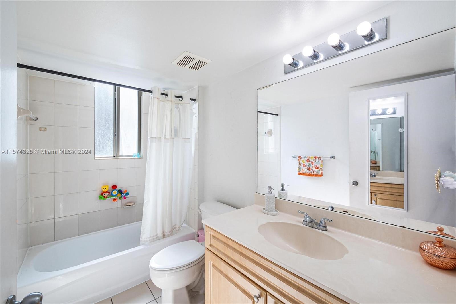 102 Southwest 6th Avenue, Unit 401 Miami, FL 33130 - Photo 22 of 27 a bathroom with a sink a toilet and a large mirror