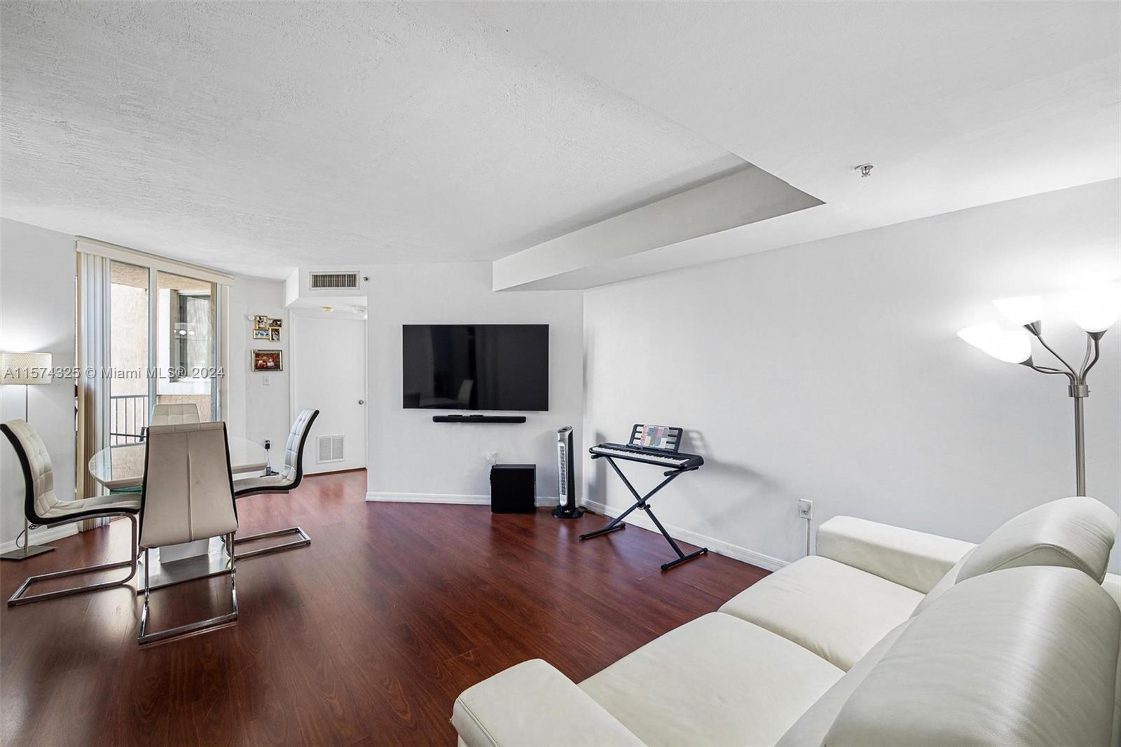 102 Southwest 6th Avenue, Unit 401 Miami, FL 33130 - Photo 6 of 27 a living room with furniture and a flat screen tv