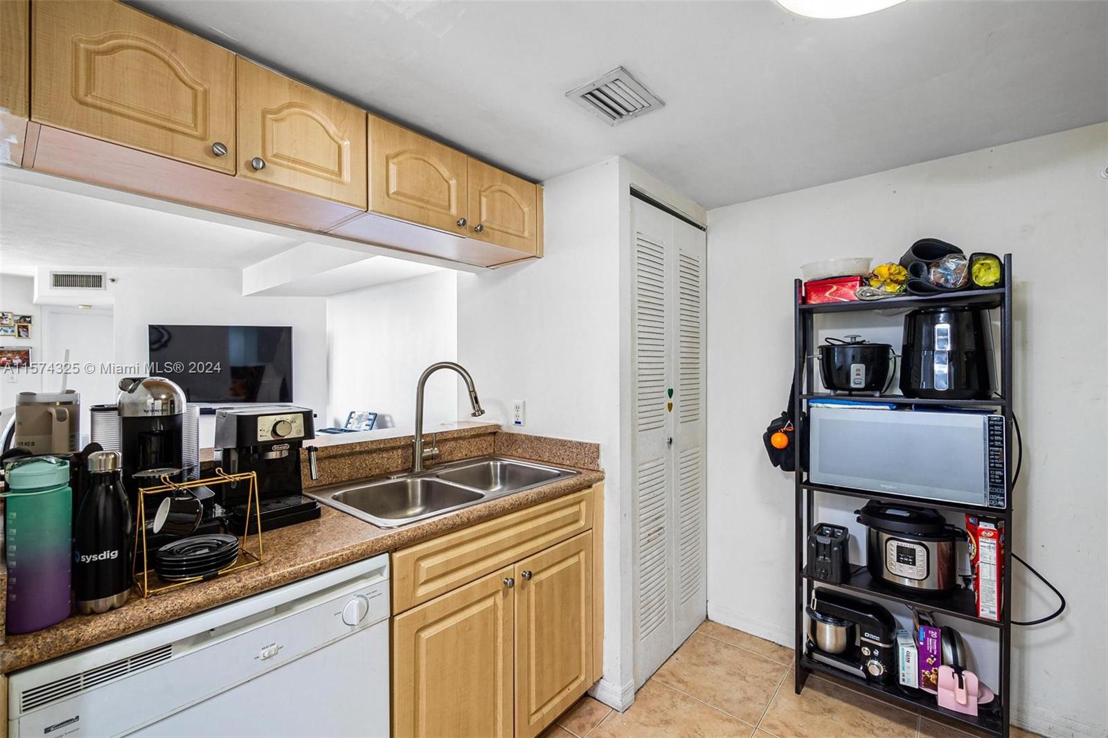 102 Southwest 6th Avenue, Unit 401 Miami, FL 33130 - Photo 9 of 27 a kitchen with stainless steel appliances granite countertop a stove and a sink