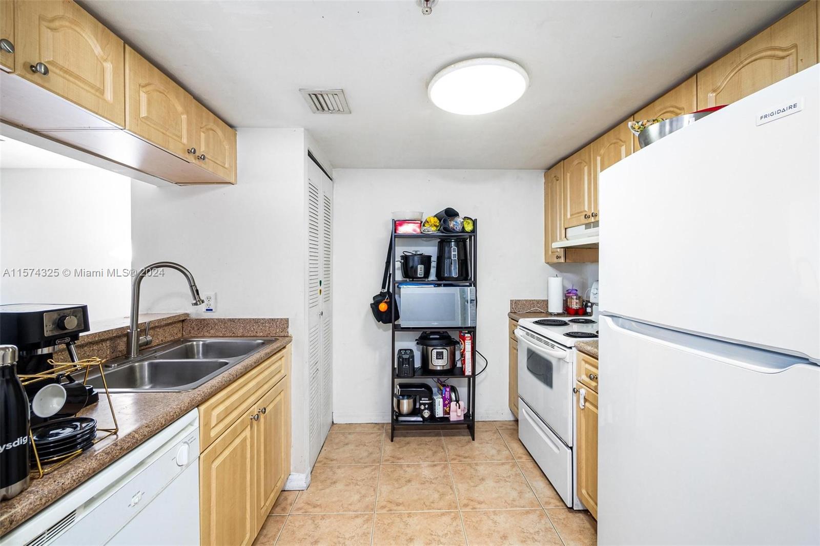 102 Southwest 6th Avenue, Unit 401 Miami, FL 33130 - Photo 10 of 27 a kitchen with stainless steel appliances granite countertop a sink and a refrigerator