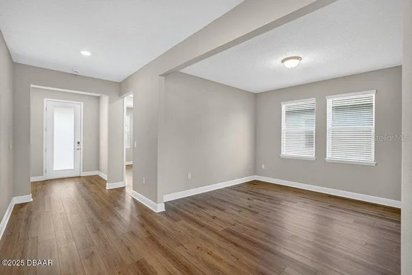 a view of kitchen and kitchen with stainless steel appliances wooden floor