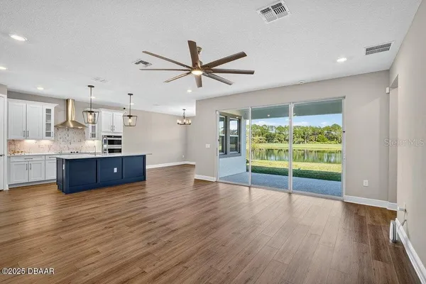 a kitchen with white cabinets and appliances