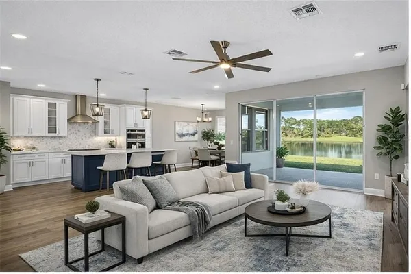 a kitchen with granite countertop white cabinets and stainless steel appliances