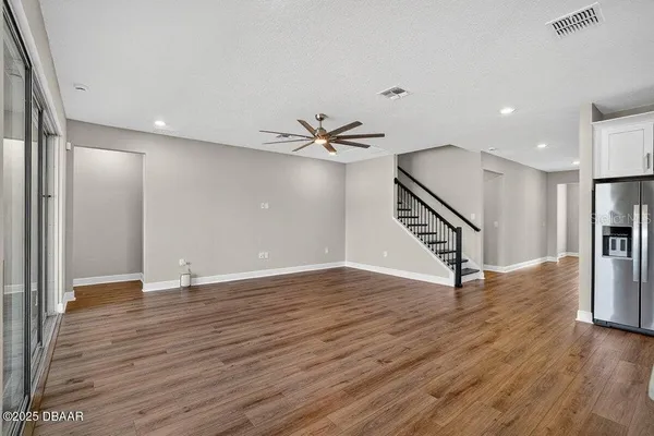 a kitchen with a counter space appliances and wooden floor