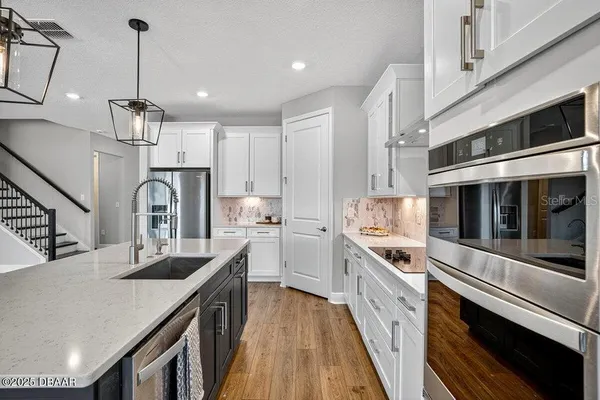 a kitchen with wooden floors and a window