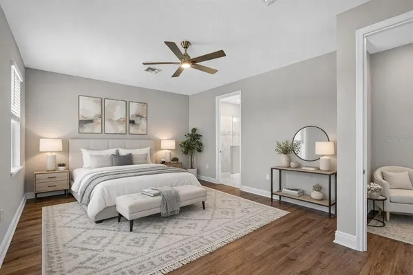 a view of a room with wooden floor and a ceiling fan