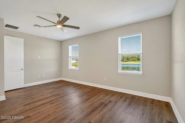 a living room with furniture a flat screen tv and a window