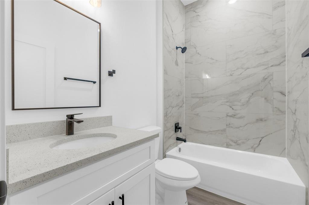3172 Southwest 137th Loop Ocala, FL 34473 - Photo 13 of 38 a bathroom with a sink a toilet and a bathtub