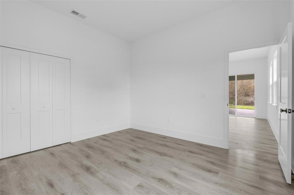3172 Southwest 137th Loop Ocala, FL 34473 - Photo 17 of 38 a view of a room with wooden floor and windows