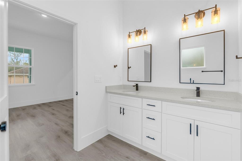 3172 Southwest 137th Loop Ocala, FL 34473 - Photo 23 of 38 a bathroom with 2 sink and a mirror