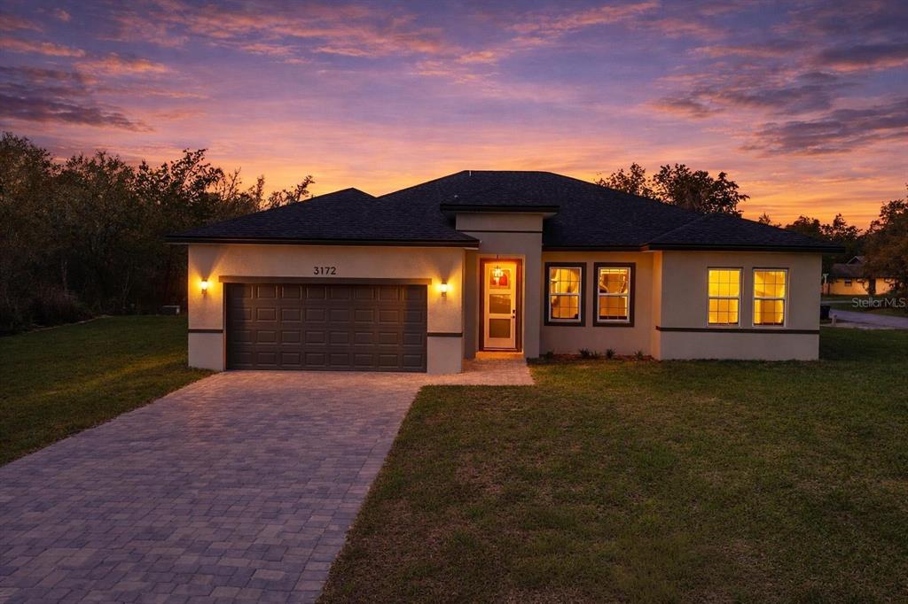 3172 Southwest 137th Loop Ocala, FL 34473 - Photo 3 of 38 a front view of a house and a yard