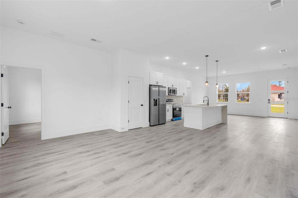 3172 Southwest 137th Loop Ocala, FL 34473 - Photo 8 of 38 a view of a kitchen with a microwave and stove