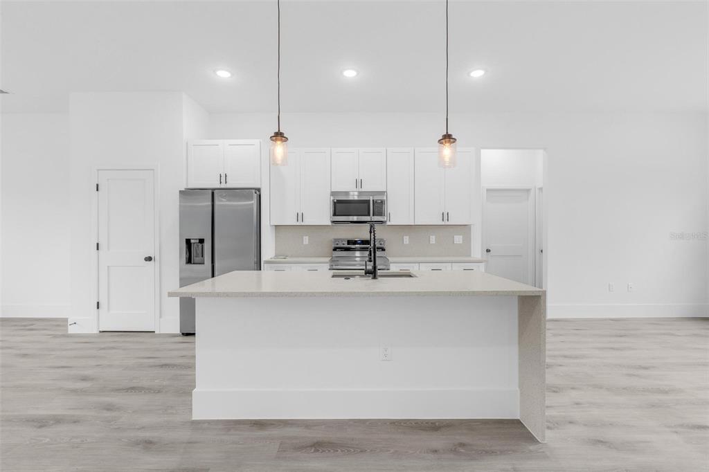 3172 Southwest 137th Loop Ocala, FL 34473 - Photo 9 of 38 a view of a kitchen with kitchen island a sink stainless steel appliances and cabinets