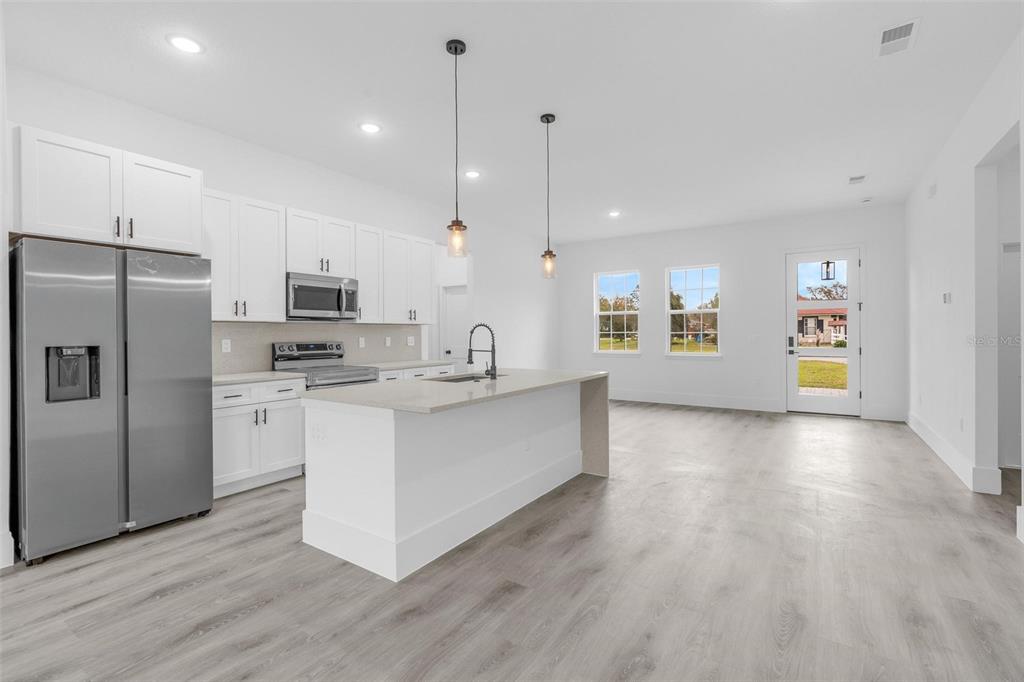 3172 Southwest 137th Loop Ocala, FL 34473 - Photo 10 of 38 a large kitchen with cabinets and stainless steel appliances