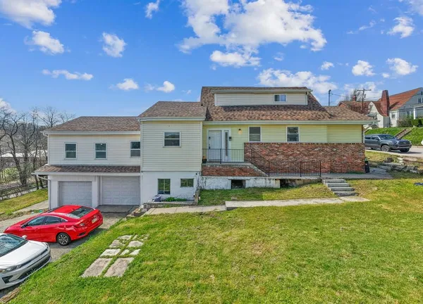 a view of a house with swimming pool and a yard