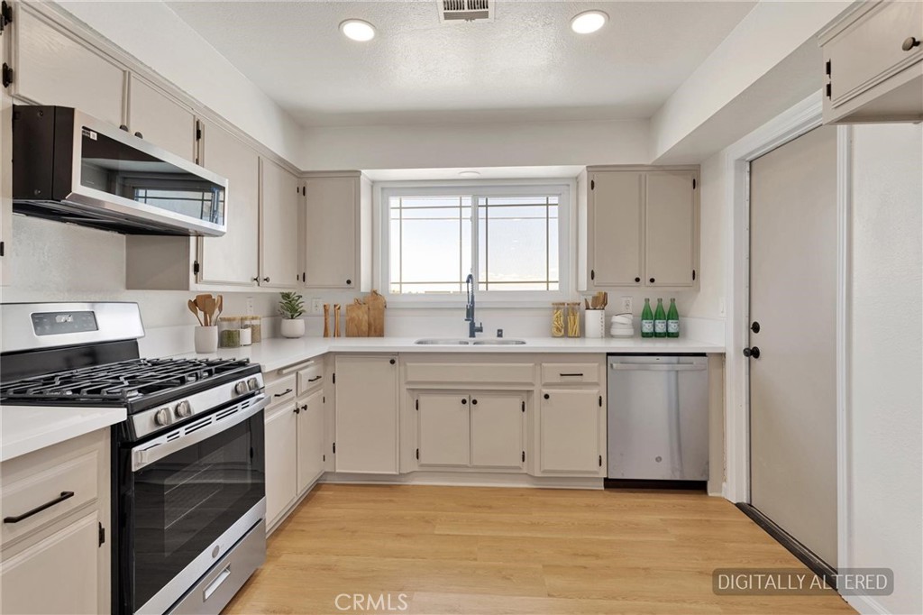 21985 Maumee Road Apple Valley, CA 92308 - Photo 8 of 28 Remodeled Kitchen (Disclaimer: Some images have been digitally enhanced with virtual staging to illustrate potential room layouts and furnishings. Actual property condition and features may vary. Buyer to verify all information independently).