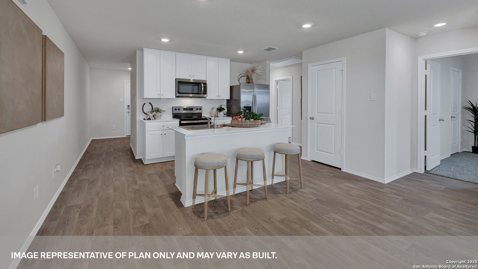 323 Low Pasture Trail Maxwell, TX 78656 - Photo 5 of 40 a kitchen with white cabinets and stainless steel appliances
