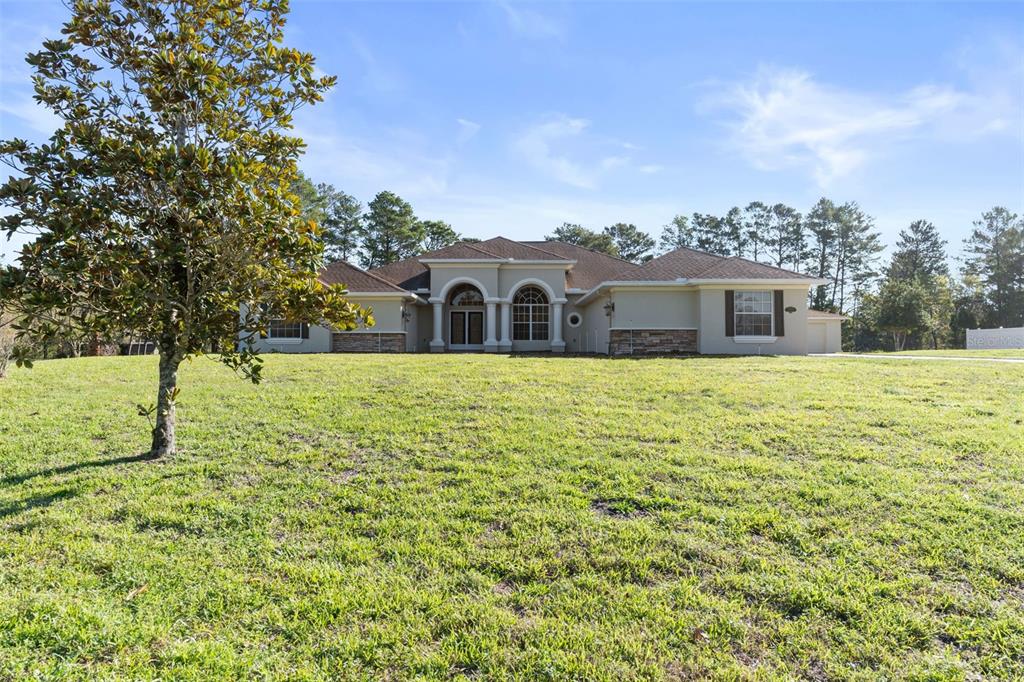 10130 Lazy Days Court Weeki Wachee, FL 34613 - Photo 1 of 85 a view of a house with yard and sitting area
