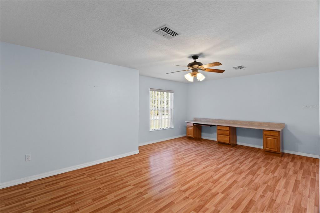 10130 Lazy Days Court Weeki Wachee, FL 34613 - Photo 28 of 85 a view of an empty room with wooden floor and a window