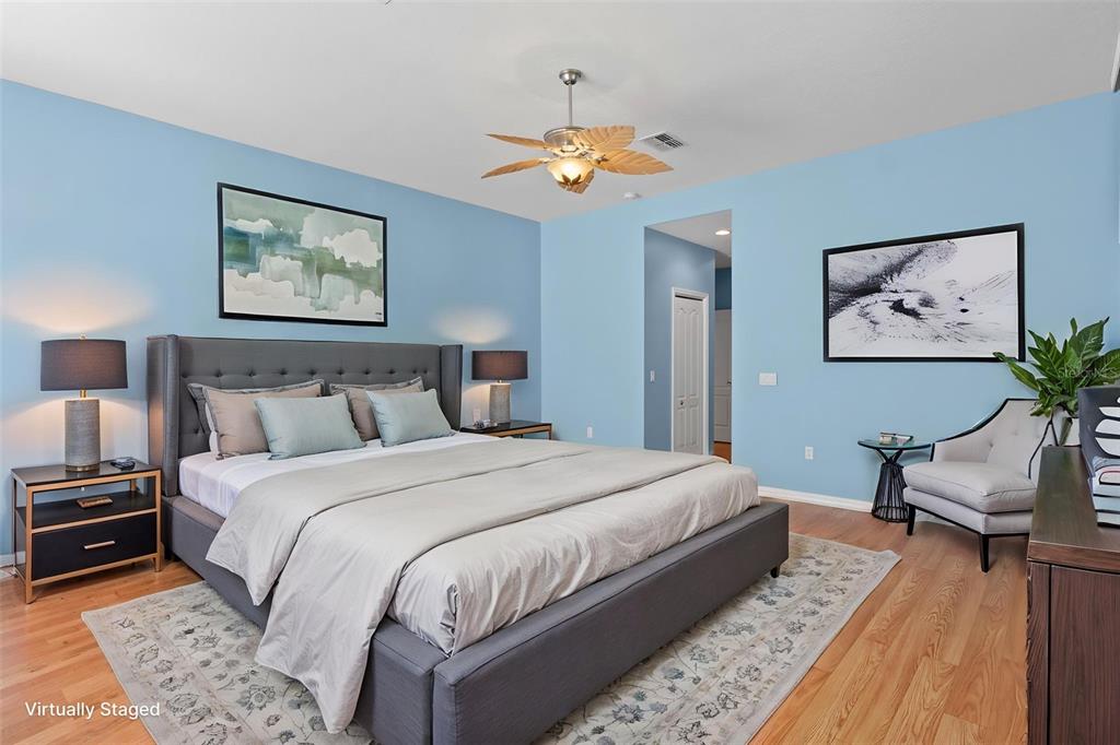 10130 Lazy Days Court Weeki Wachee, FL 34613 - Photo 40 of 85 a bedroom with bed and a chandelier