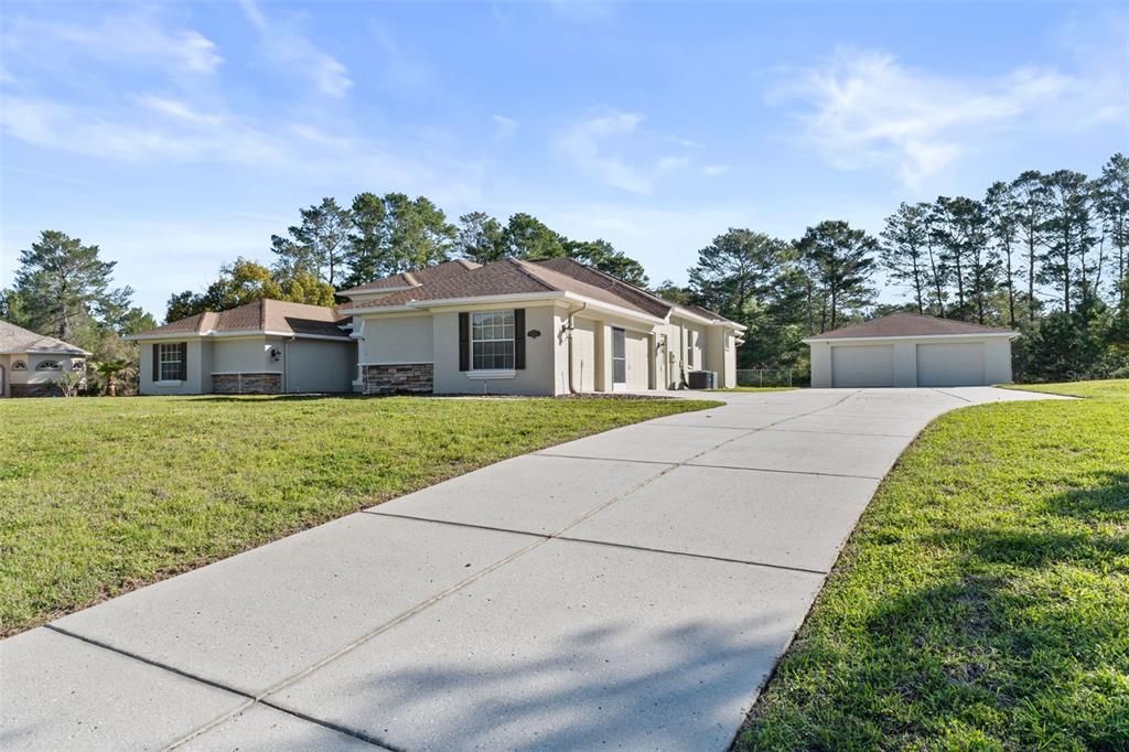 10130 Lazy Days Court Weeki Wachee, FL 34613 - Photo 4 of 85 a front view of a house with garden