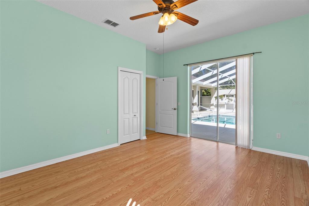 10130 Lazy Days Court Weeki Wachee, FL 34613 - Photo 42 of 85 a view of an empty room with wooden floor and a window