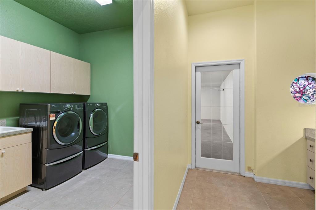 10130 Lazy Days Court Weeki Wachee, FL 34613 - Photo 57 of 85 a view of storage and utility room with a washer and dryer