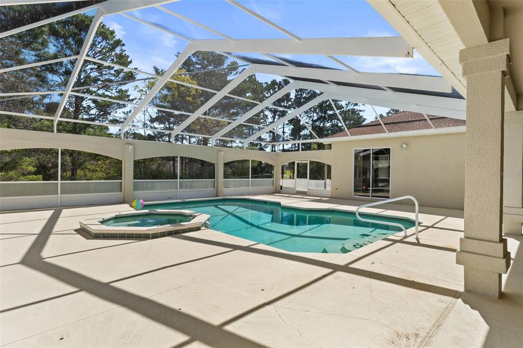 10130 Lazy Days Court Weeki Wachee, FL 34613 - Photo 69 of 85 a view of a white house with a yard and potted plants
