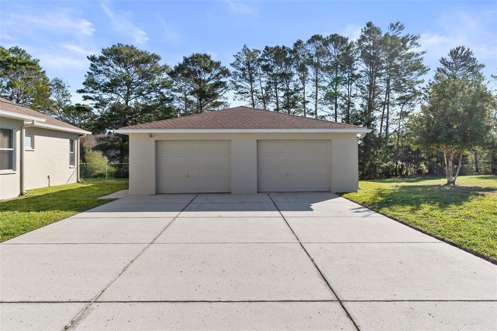 10130 Lazy Days Court Weeki Wachee, FL 34613 - Photo 70 of 85 front view of a house with a yard and trees