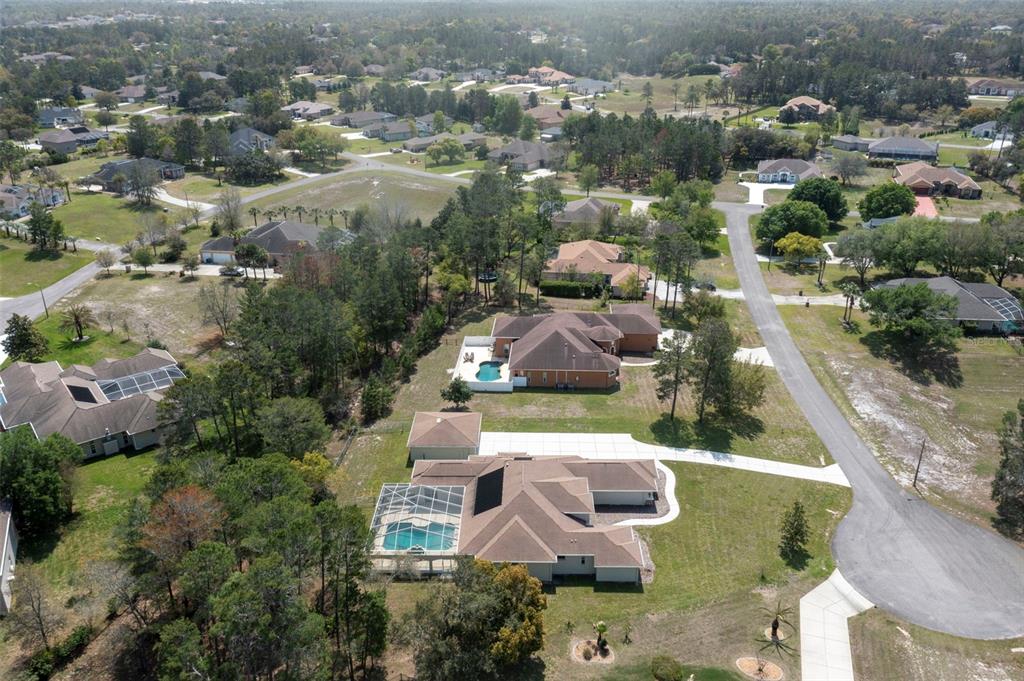 10130 Lazy Days Court Weeki Wachee, FL 34613 - Photo 82 of 85 an aerial view of a house with swimming pool and mountains